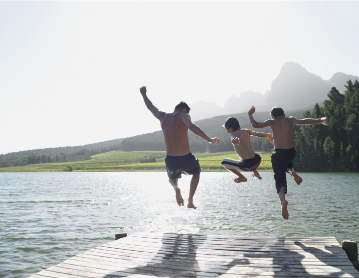 Father-and-sons-jump-into-a-lake